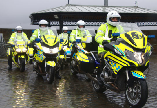 Police officer taking off on their bikes at Discovery Point.