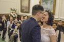 Yuting Ling and Kanheng Zhou celebrate becoming husband and wife.