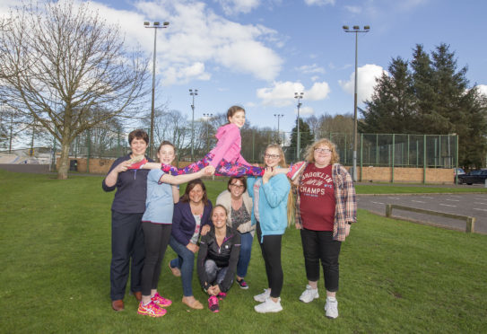 Phoenix Gymnastics Club members in front of the disused tennis courts at the former Lochside Leisure Centre in Forfar. The pciture shows Isla Graham up high with, from left, Deborah Graham, Lucy Hickie, Jennifer Meek, Shona Forbes, Lynne Warburton, Kayleigh Meek and  Fiona Reid
DC Thomson.
.