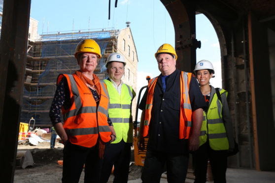 Gillian Lange (left) and Dave Cosgrove 3rd from left), Daisy Tasker's grandchildren outside the former mill with William Inglis - General Manager and Ashley Blake - Digital Marketing Manager at blue2.