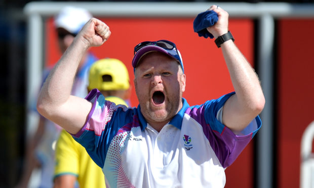 Darren Burnett celebrates during the Men's Lawn Bowls Triple's on day four of the Gold Coast 2018 Commonwealth Games.