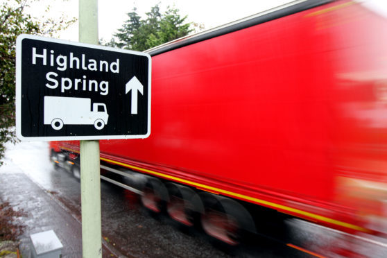A lorry passing a
sign for Highland Spring in Blackford.