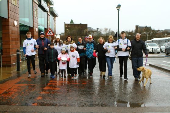 Euan Fellows, 5th from right, with friends and staff from Morrisons, heading off from the Morrisons store in Arbroath on their sponsored walk to Easthaven and back, to raise money for CLIC Sargent.
