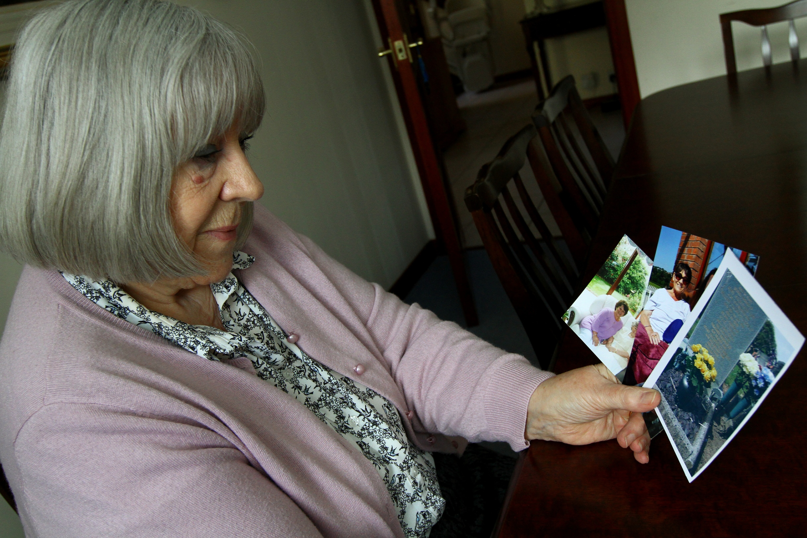 Patsy Kilbride looking at photos of her sister Janet Cameron.