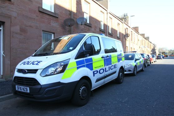 Police outside a property in Arbroath after a baby was rushed to hospital last month.
