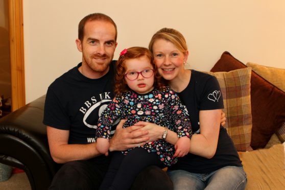 Caitlin Wilkie at home with mum Ashley and  dad Liam.