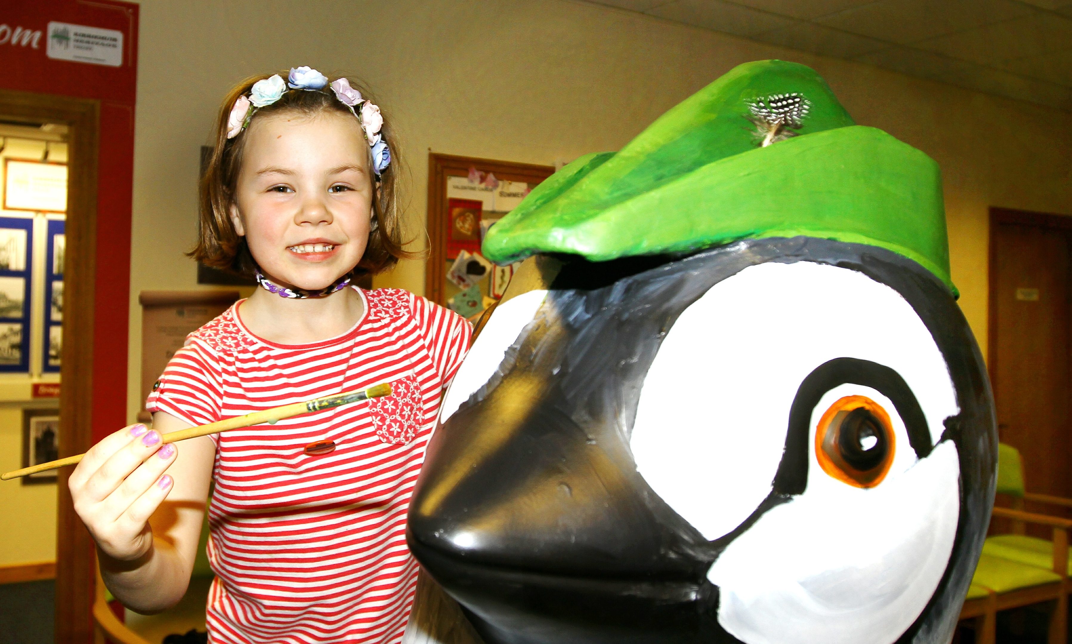 Seven year old Holly Stephen from Glamis helping to paint the penguin.