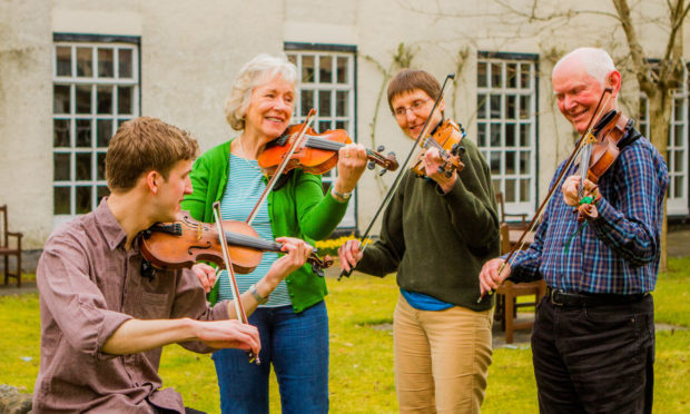 Fiddle Workshop with tutor Charlie Stewart; left to right is fiddle player Charlie Stewart (from Glenfarg, now Glasgow), Fiona Towns (from Freuchie, Fife), Aileen Brown (from Shetland) and Mike Bennett (from Yorkshire). Green Hotel, 2 Muirs, Kinross.