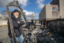 Robert Love by the remains of his burnt-out caravan.