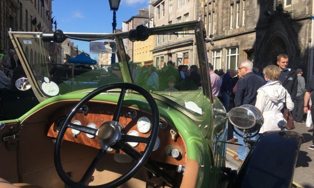 Visitors check out vehicles on Tay Street.