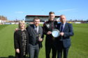 Linda Baird and Reece Baird with Thomas O'Brien being presented with the Geordie Baird Memorial Trophy as the manager's Player of the Year by George Baird.