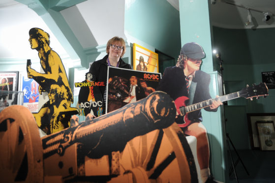 Museum officer Rachel Jackson with memorabilia from the Bon Scott exhibition being staged for this weekend's Bonfest