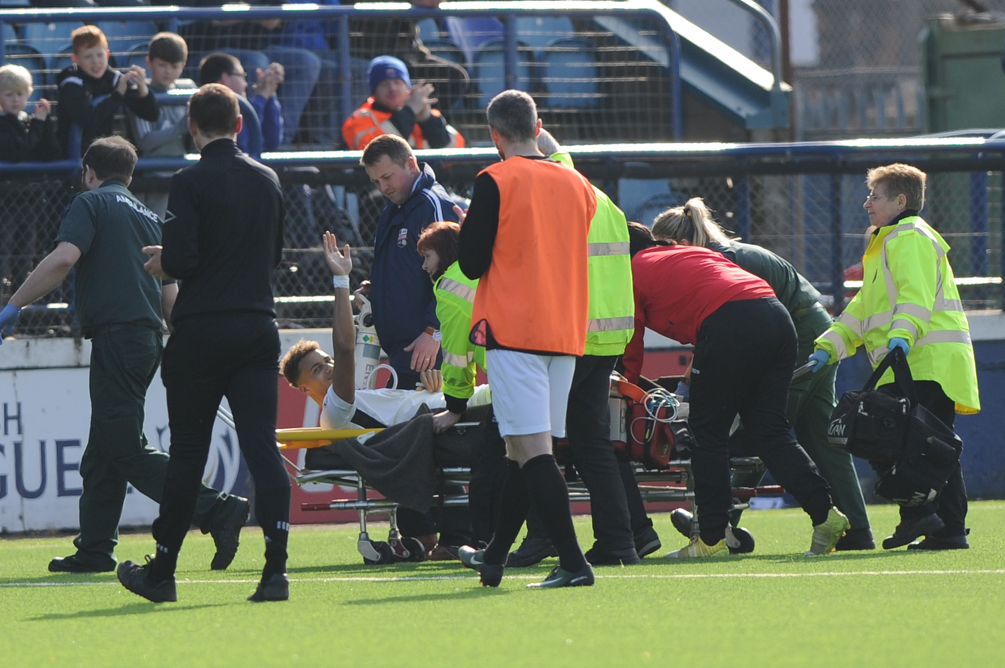 Brave Ousman See beckons to the fans as he is stretchered off.