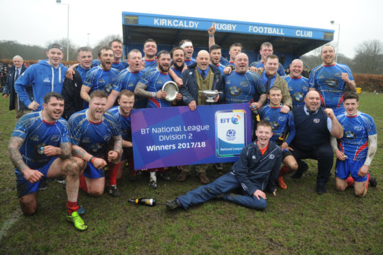 Club president Jimmy Bonner with the National keague Two Trophy and the victorious Kirkcaldy team.
