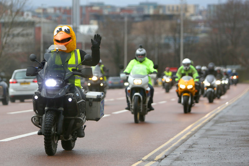 Alan Kelly from Scotriders leading motorbikes leaving Scotriders with a police escort.