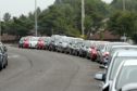 The row of cars parked in the unofficial "overspill car park" outside the Ninewells Hospital grounds.