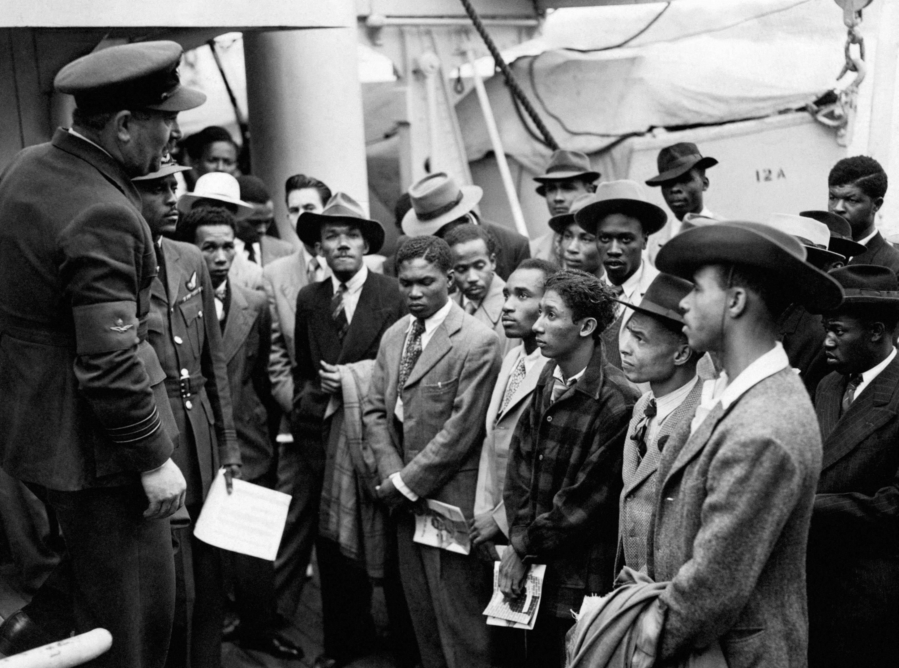 Jamaican immigrants with RAF officials from the Colonial Office after the ex-troopship HMT "Empire Windrush" landed them at Tilbury in Essex in 1948.