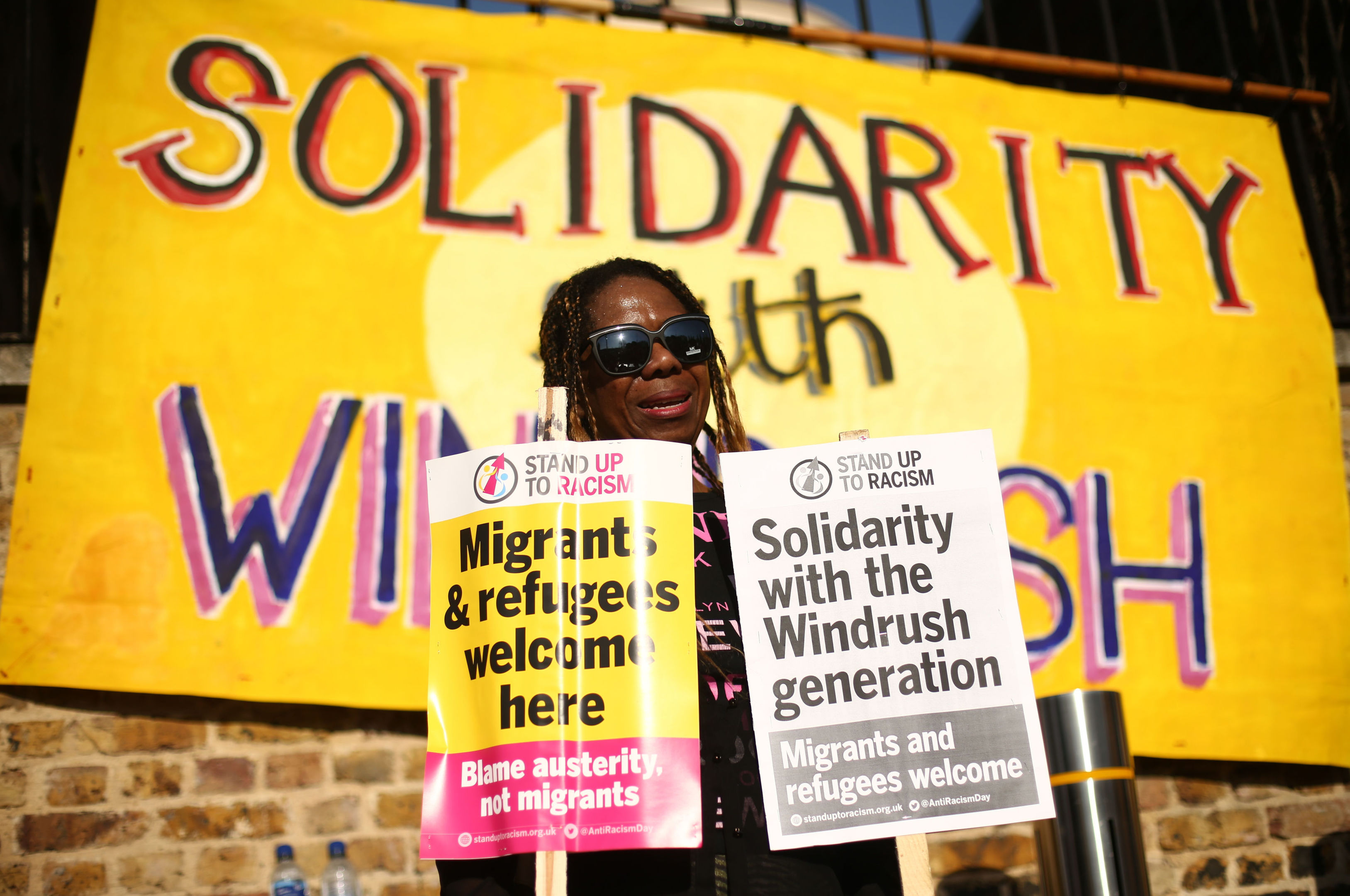 People attend an event in Windrush Square, Brixton, south London, organised by Stand up to Racism in solidarity with the Windrush generation and their families.