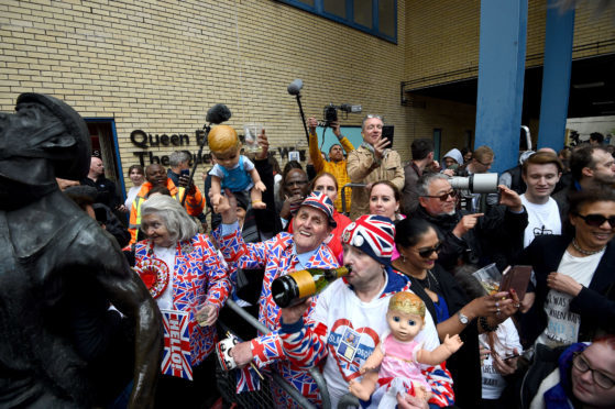 Royal fans celebrate outside the Lindo Wing at St Mary's Hospital in Paddington, London after the news that the Duchess of Cambridge has given birth to a son.