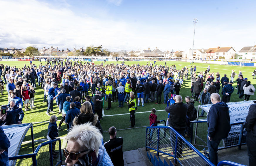 Montrose fans invade the pitch at full time after winning the league