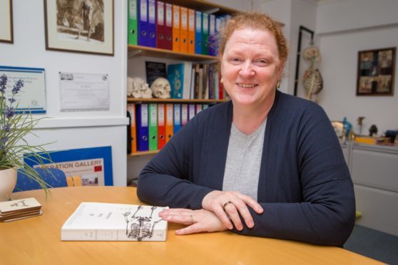 Professor Dame Sue Black in her old office with her award winnig book All That Remains.