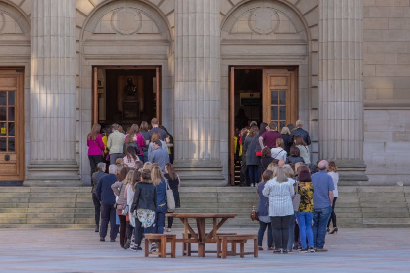 Fans queuing outside the Caird Hall.