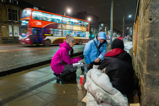 Rail Pastor Moss Barclay speaks to homeless man Colin Todd (31) as he settles down for the night while chatting to Courier Reporter, Gayle Ritchie telling his story.