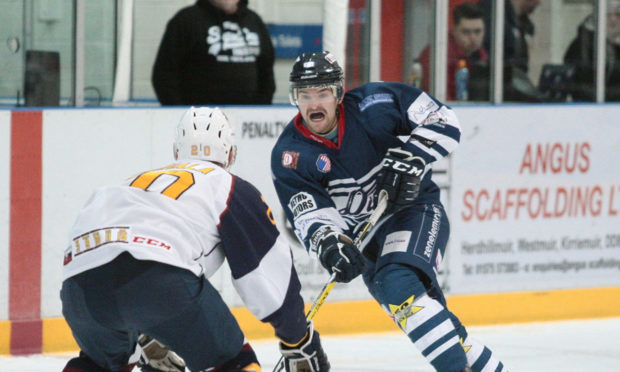 Dundee Stars player Brian Hart goes one-on-one with the Flames' Tomas Nechala