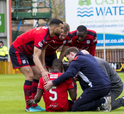 Dundee's Genseric Kusunga before being stretchered off.