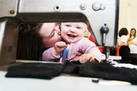 Zoe Smith with Tilly Fox, 1, getting to grips with the sewing machines.