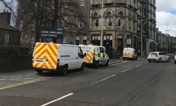 Officers and vehicles at the scene.