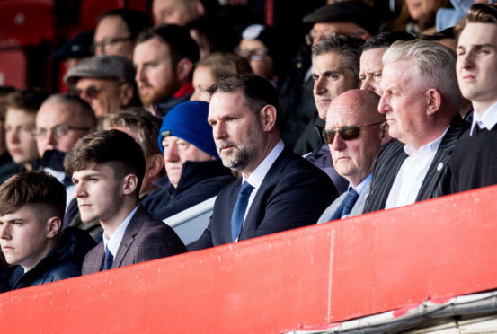 Dundee managing director John Nelms (centre) says it is costing £300,000 a year to keep Dens Park operational.