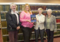 Historical Society members David Orr, Alice Bremner and Aileen Elliott presenting the new book to Angus Alive facilities officer  Claire Tracey at Forfar library