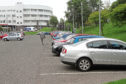 A correspondent says Angus councillor Colin Brown should not be considering charging staff to park, as is the case at Ninewells Hospital.
