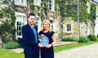 Anne MacDonald receives the Old Manses ratings plaque from Neil Christison of Visit Scotland