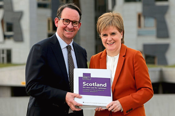 First Minister Nicola Sturgeon receives the Sustainable Growth Commission report from commission chair Andrew Wilson.