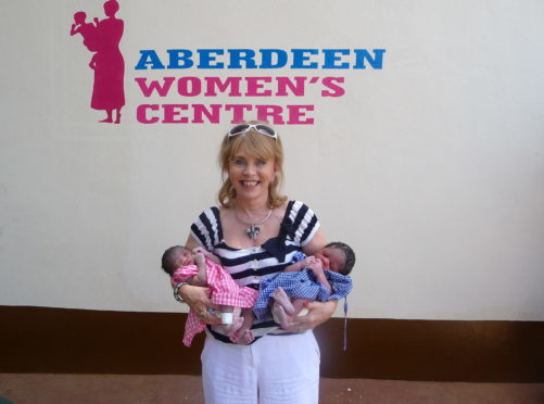 Ann Gloag with twins at the Aberdeen Women's Centre in Sierra Leone.