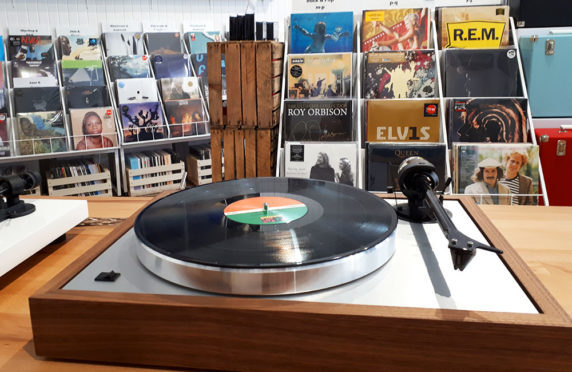A record on a turntable within Assai's Dundee shop