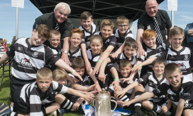 Some of the Mini Section Rugby Club members pictured with the Calcutta Cup.