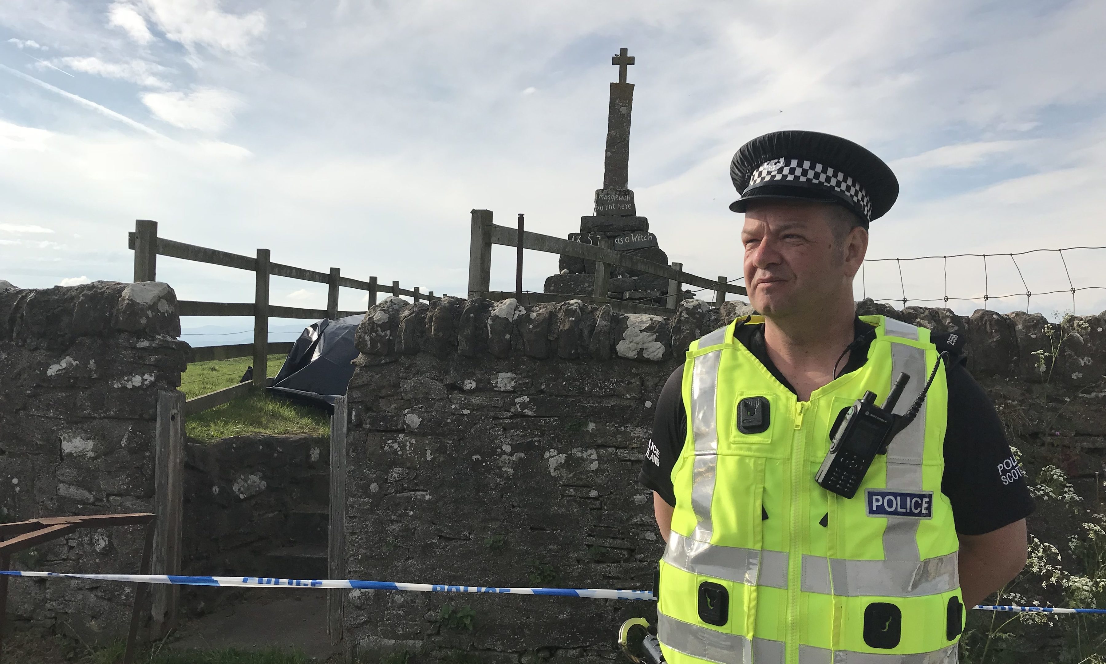 Police guard the Maggie Wall memorial near Dunning.