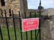 The sign warning students has gone up on fencing above Castle Sands.