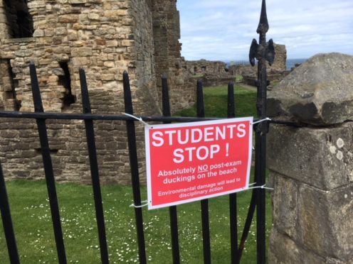 The sign warning students has gone up on fencing above Castle Sands.