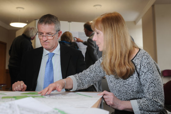 Euan Cameron discusses the plans with Jacquie Forbes, consulting architect for the project.