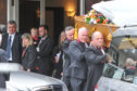 Pallbearers carry the coffin of Liam Colgan.