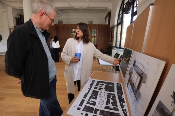 Local resident James Watt is shown the plans by architect Carmen Pereira of Mecanoo Architects.