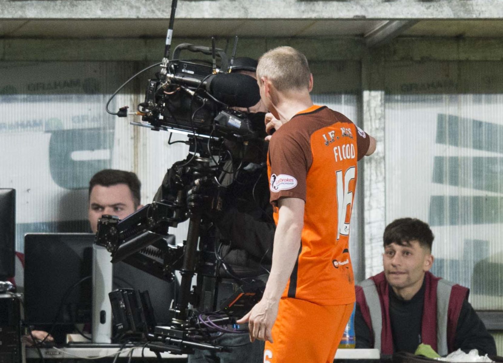 Willo Flood has an argument with a TV camera after his red card.