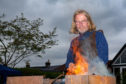 Blacksmith Jim Shears at his forge showing visitors how to manage metal