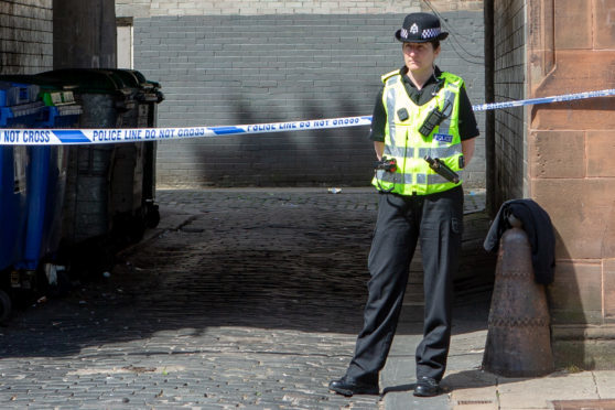 Police protecting the scene on Monday.