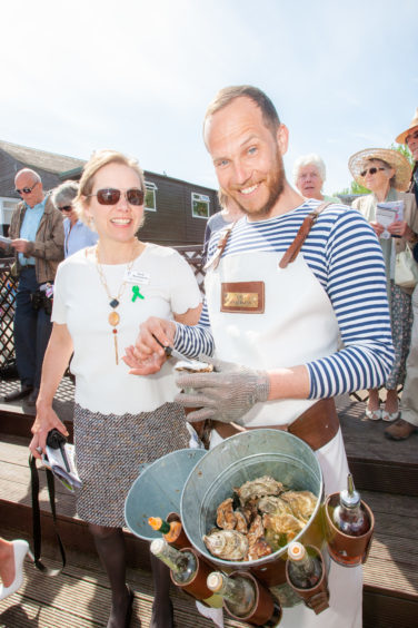 Hazel Peplinski (Racecourse chief executive) trying oysters from 'The Oysterman' Ferras Seguer.