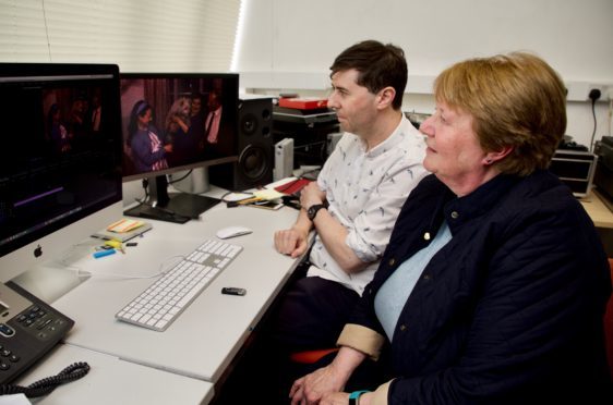 Adam Lockhart and Linda Gellatly looking at the footage